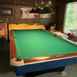 Vintage Brunswick Pool Table, cues and cue cabinet